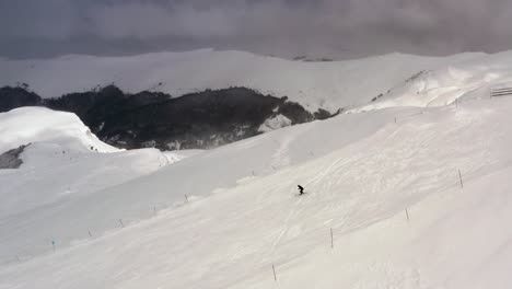 AERIAL---Person-skiing-in-the-mountain-at-Kolasin-ski-resort,-Montenegro,-static