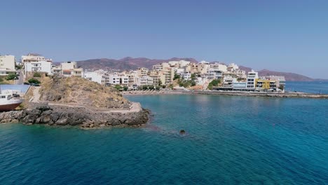 drone-shot-over-the-marina,-seaside-boulevard,-beaches,-summer-in-Agios-Nikolaos-Crete-Greece