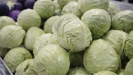 Close-up-of-green-cabbage-heads-on-display-at-the-supermarket