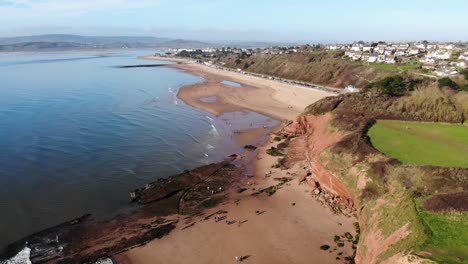 Orcombe-Beach-And-Cliff-Coastline-In-Exmouth-With-Visitors-On-Beach-On-Sunny-Day