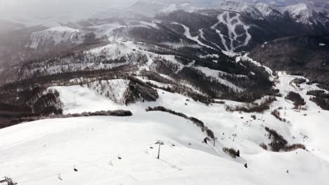 AERIAL---Ski-lift-in-the-mountains-on-a-sunny-day-at-Kolasin-ski-resort,-Montenegro