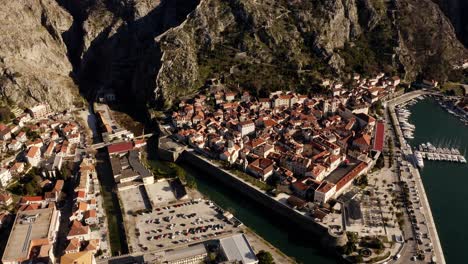 AERIAL---Bay-of-Kotor-and-city-walls,-Kotor,-Montenegro,-pan-left