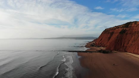 Aerial-Over-Beach-Coastline-With-Orcombe-Point-Cliffs-Looking-Into-Horizon