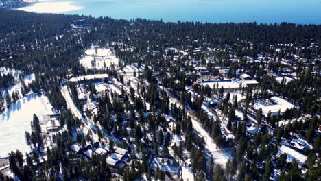 Aerial-drone-shot,-flying-over-buildings-in-the-woods-in-Lake-Tahoe,-Nevada-California
