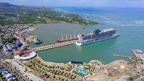 Drone-view-of-luxury-cruise-liner-docked-in-port,-Taino-Bay,-Caribbean
