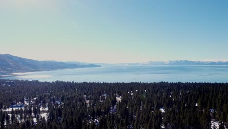 Aerial-drone-shot,-a-panorama-shot-of-the-crystal-clear-water-with-beautiful-teal-sky-in-Lake-Tahoe,-Nevada-California