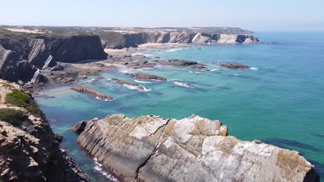 Aerial-Drone-View-of-the-coast-at-Carvalhal,-Alentejo,-West-Portugal---Steep-Cliffs-and-rocky-coastline