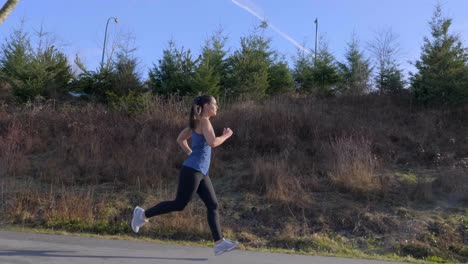 Tracking-gimbal-shot-young-athletic-woman-out-running-Slow-motion