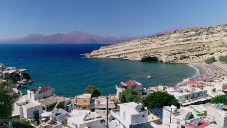 Beautiful-view-from-a-drone-flying-over-the-beach-and-bay-in-Matala-Crete-Greece