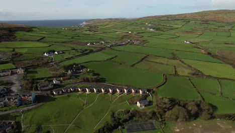 Aerial-View-of-Coastal-Village-and-Green-Fields-in-Irish-Landscape-on-Sunny-Day