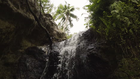 Slow-mo,-water-flowing-down-small-tropical-waterfall