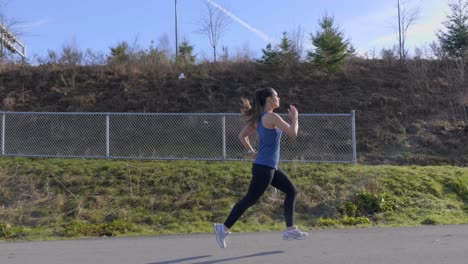 Young-fit-woman-out-for-morning-run-slow-motion-Tracking-shot