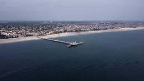 An-amazing-aerial-drone-shot,-drone-flying-towards-Belmont-Veterans-Memorial-Pier-in-Long-Beach,-California