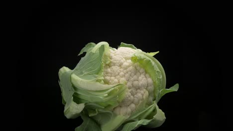 A-single-cauliflower-moves-into-frame-on-a-dark-background-and-underground
