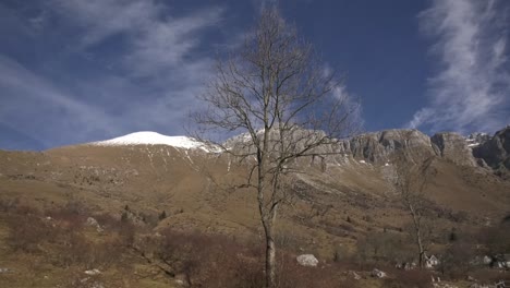 wide-panorama-pan-of-epic-Slovenian-mountains-on-cold-winter-day,-Krn-covered-in-snow