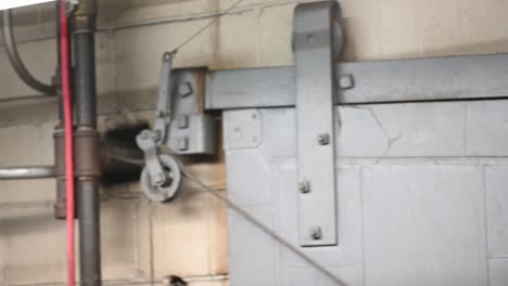 right-to-left-view-of-a-industrial-safety-blast-door-at-a-welding-shop