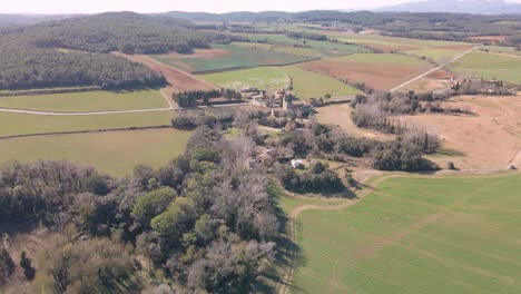 Aerial-image-of-sown-fields-and-a-spectacular-farmhouse-in-Girona-province-of-Spain