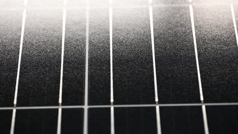 slow-close-up-of-a-solar-panel-sliding-right-to-left-in-the-light