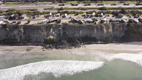 A-stunning-aerial-drone-shot,-flying-along-the-coast,-Carlsbad-State-Beach---California