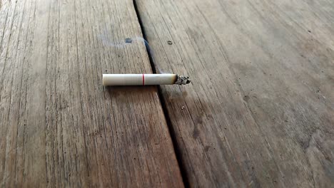 Close-up-of-a-cigarette-with-a-beautiful-puff-of-smoke-when-placed