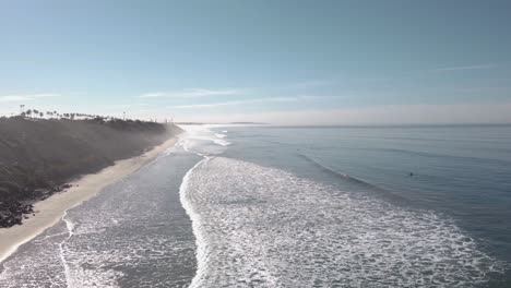 A-beautiful-aerial-drone-shot,-static-shot-of-the-coastline-during-golden-hour,-Carlsbad-State-Beach---California