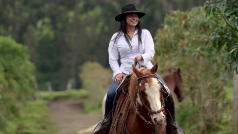 Cowgirl-riding-her-brown-horse