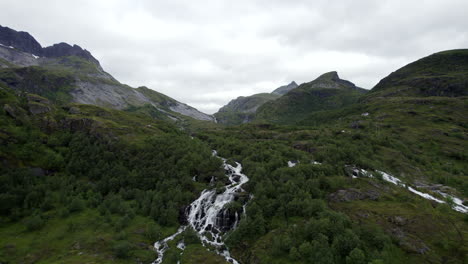 Aerial-Forwarding-shot-of-a-waterfall-coming-from-trolldalsvatnet-on-Lofoten-Islands-in-Norway