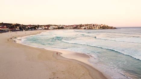 Drone-aerial-view-of-the-famous-Bondi-Beach-at-the-sunset,-Australia