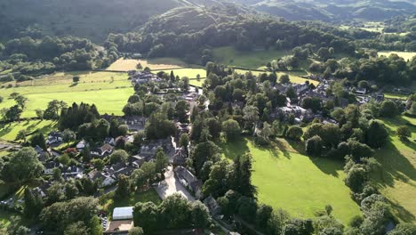 Aerial-video-footage-Grasmere-Village,-Town-in-the-Cumbrian-Lake-District-National-Park-England-UK-on-a-beautiful-summers-evening