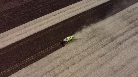 Aerial-footage-of-a-feed-bean-harvest-in-Aylesham,-with-a-combine-harvester