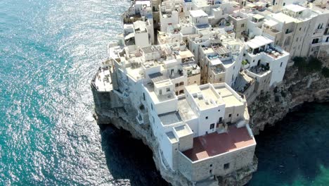Drone-capture-the-rotating-shot-of-Polignano-a-Mare,-its-a-town-on-Italy-located-on-the-Adriatic-coast
