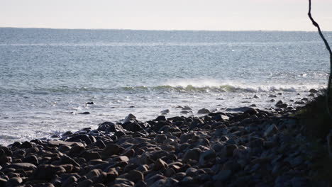 Ocean-Waves-Crashing-On-Rocky-Beach-Shoreline,-4K-Slow-Motion