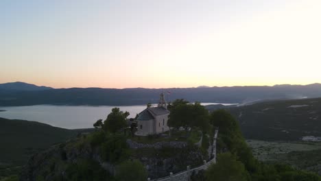 Hilltop-church-against-lake-and-mountains