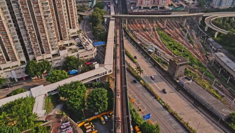 Kowloon-Bay-MTR-Station-in-Kwun-Tong-Road,-Hong-Kong,-Cinematic-Aerial-tilt-up