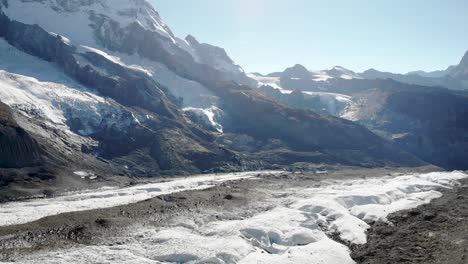 Aerial-view-of-the-Matterhorn,-Gorner-glacier-and-Dufourspitze-in-a-panning-panoramic-view-on-a-sunny-summer-afternoon-in-Zermatt,-Switzerland