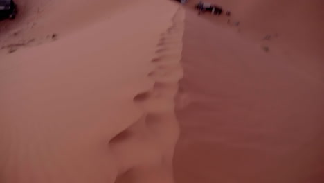 POV-running-in-Sahara-desert-sand-dunes,-slow-motion,-Erg-Chebbi,-Merzouga-Morocco
