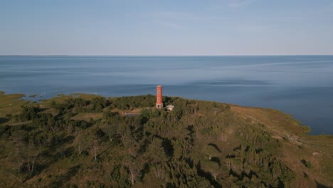 Awesome-nature-panorama-aerial-drone-flight-old-lost-place-lighthouse-at-the-coast-of-baltic-sea---Estonia-in-Europe---nature-helicopter-flyover-establishing-shot-summer-2022---bird-view---blue-ocean