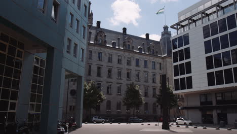 Slowmotion-dolly-shot-of-Rotterdam-town-hall,-surrounded-by-office-buildings,-Netherlands