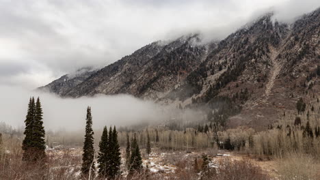 Time-lapse-of-clouds-swirling-around-high-mountain-peaks-and-fog-rolling-up-from-the-valley