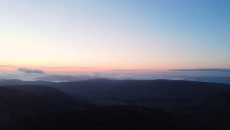 High-angle-pan-shot-over-highlands-in-Peak-District-National-Park-during-evening-time