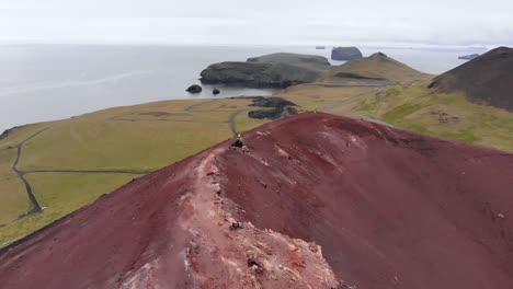 Aerial-zoom-out-from-Eldfell-vulcano-on-Heimaey-island-in-Iceland