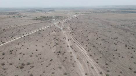 rising-aerial-footage-of-several-dirt-roads-running-through-a-stretch-of-arid-area