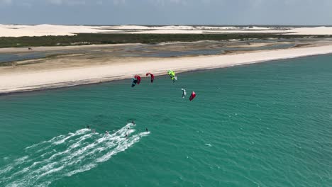 Group-of-kiteboarders-having-fun-together---downwinder-along-coastline