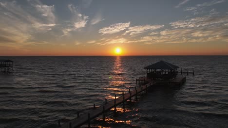 Aerial-pan-view-of-sunset-off-Mobile-Bay,-Alabama