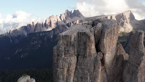 Aerial-view-moving-over-the-towers-of-Cinque-Torri,-revealing-the-majestic-Croda-Da-Lago-range-in-the-Dolomites,-Italy