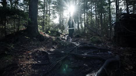 Female-Hiker-At-The-Woods-On-Sunny-Morning-In-The-Park-of-the-Chute-à-Bull-In-Saint-Côme,-Quebec,-Canada