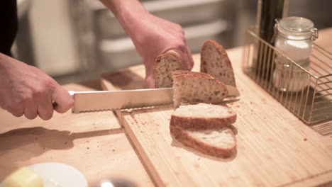 A-man-cuts-fresh-bread-with-a-knife