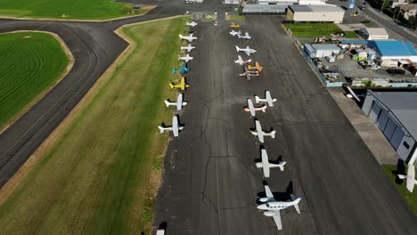 Airplanes-At-Chilliwack-Airport-In-British-Columbia,-Canada---aerial-drone-shot