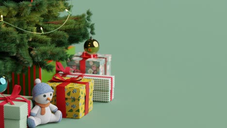 Christmas-tree-with-gifts-and-teddy-bear-with-copy-space-on-green-background