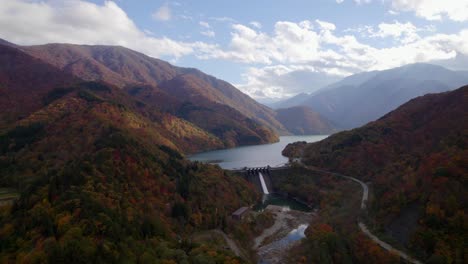 A-fly-over-the-Japanese-Alps,-its-lakes-and-dam